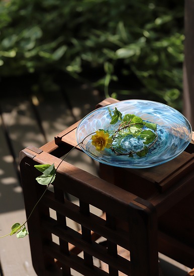 青いガラスのスープ皿に花を生ける